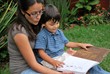 Young Hispanic mother reads to her son