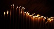 Many candles in a row in dark church Many candles in a row in dark church