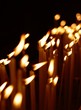 Many candles in a row in dark church Many candles in a row in dark church