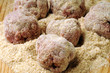 Beef meatballs being prepared on wooden chopping board Beef meatballs being prepared on wooden chopping board