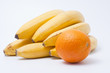 Cluster of ripe bananas and orange