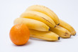Cluster of ripe bananas and orange