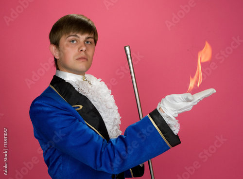 Photo: Prestidigitator with fire on arm. Prestidigitator with fire on arm.