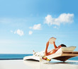 Young man relaxing on his holiday, reading a book