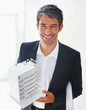 Successful builder holding a miniature building