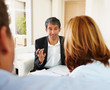 Successful bank executive in a discussion with a couple Successful bank executive in a discussion with a couple