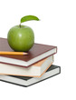 Green apple and pencil on pile of books