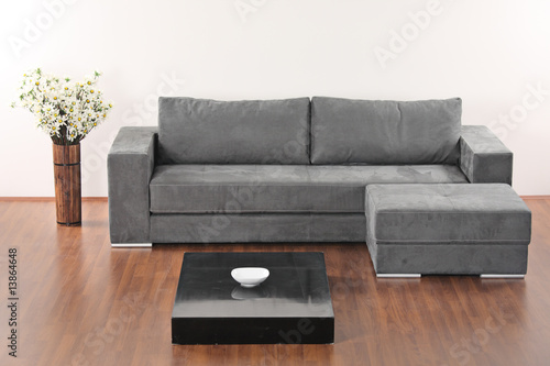 A modern minimalist living-room with grey furniture