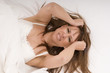 woman in bed suffers from a headache