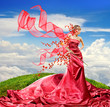 Beautiful girl in a long red dress holds exotic flower in a hand