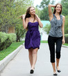 Full length, beautiful young girls walks in park