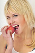 blond girl eating an apple