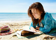 Pretty girl reading novel at beautiful beach Pretty girl reading novel at beautiful beach