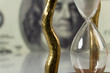 hourglass on big dollar background hourglass on big dollar background