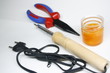 pliers and soldering iron on white background