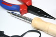 pliers and soldering iron on white background