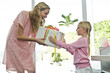 Girl giving present to her mother