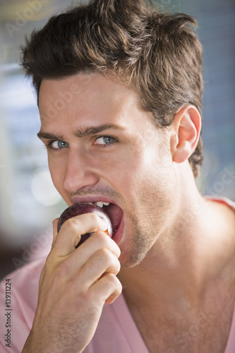 Photo: Portrait of a man eating a nectarine Portrait of a man eating a nectarine