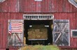 American flag hanging from a barn door American flag hanging from a barn door