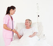 Elderly woman lying in hospital bed
