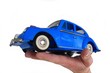 Isolated hand holding a car