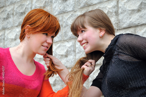 Photo: Two beautiful sisters pull each other's hair Two beautiful sisters pull each other's hair
