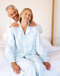 Mature man giving a shoulder massage to his wife