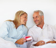 Romantic mature couple giving anniversary gift