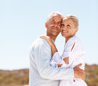 Portrait of an senior old couple embracing together