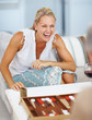 Happy mature woman playing backgammon
