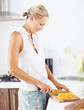 A woman slicing vegetables in the kitchen