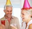 An elderly couple enjoying in a birthday party
