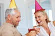 Cheers: Elderly couple at a birthday celebration