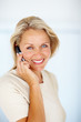 A mature woman speaking using a mobile phone