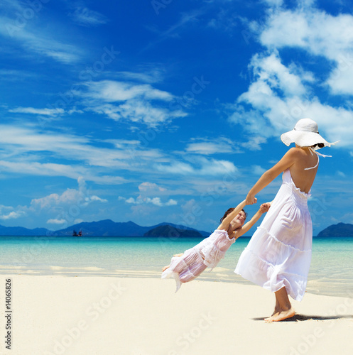 Photo: woman and girl on the beach woman and girl on the beach