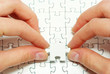 hands holding puzzle