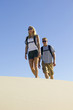 Couple Hiking through Sand Dunes