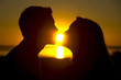A couple about to kiss at sunset A couple about to kiss at sunset