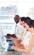 Man smiling at camera in a call centre