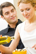 Young happy family cooking together at home