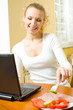 Young happy woman with laptop eating Young happy woman with laptop eating