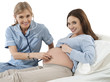 Nurse examining pregnant woman lying on hospital bed, smiling, portrait, cut out