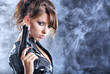 beautiful sexy girl holding gun . smoke background