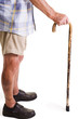 old man in shorts holding onto wooden cane