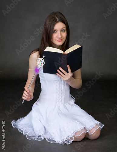 Photo: Girl with the book and a magic wand Girl with the book and a magic wand
