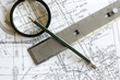 blueprint with pencil, loupe and steel scale ruler