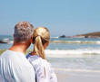 Rear view of a mature couple looking at the waves