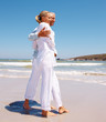 Mature couple looking away while standing on the beach