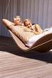 Portrait of an aged couple relaxing in hammock