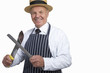 Photo: Butcher in uniform sharpening knife, cut out Butcher in uniform sharpening knife, cut out